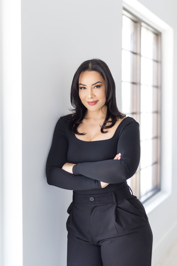 Keline Baez, NP-C beside a window at the studio