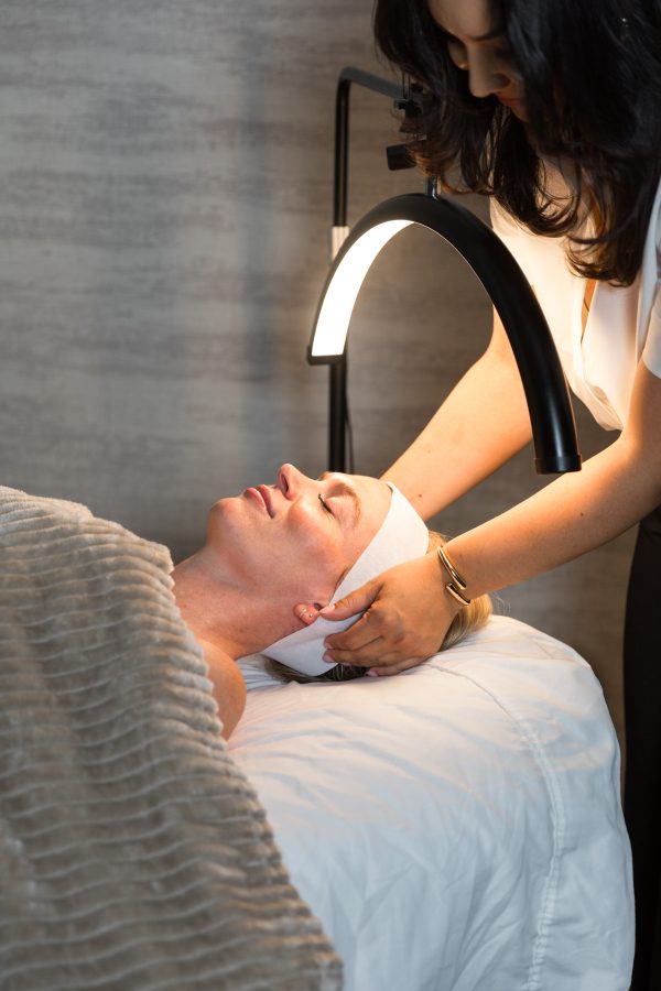 A client receiving a light-based facial treatment at The Beauty Lab